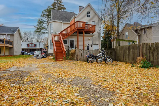 a view of a house with a yard and sitting area