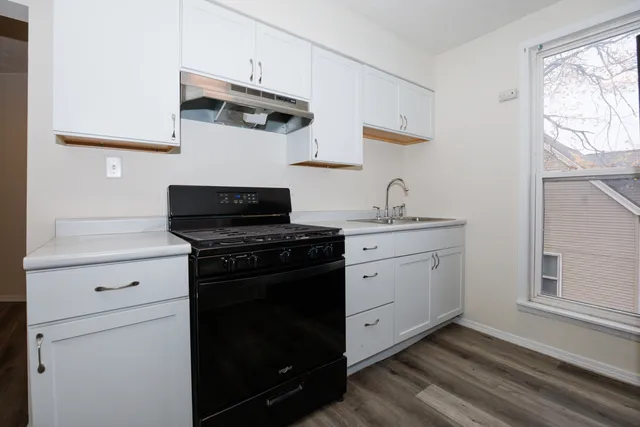a kitchen with appliances cabinets and a window