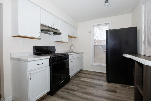a kitchen with a refrigerator and a stove