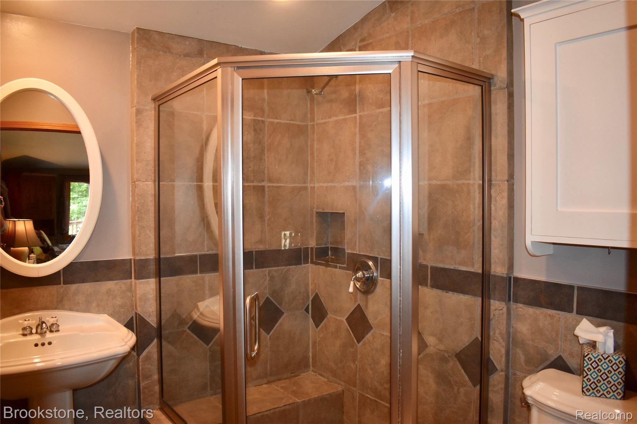 405 Baldwin Ridge Oxford, MI 48371 - Photo 36 of 54 CHECK OUT THE "OVERSIZED" SHOWER IN THE LARGE MASTER BATH (8X8). FEATURES INCLUDE CERAMIC TILE IN SHOWER, LARGE CERAMIC TILE SEAT IN SHOWER & CERAMIC TILED WALLS & FLOOR.