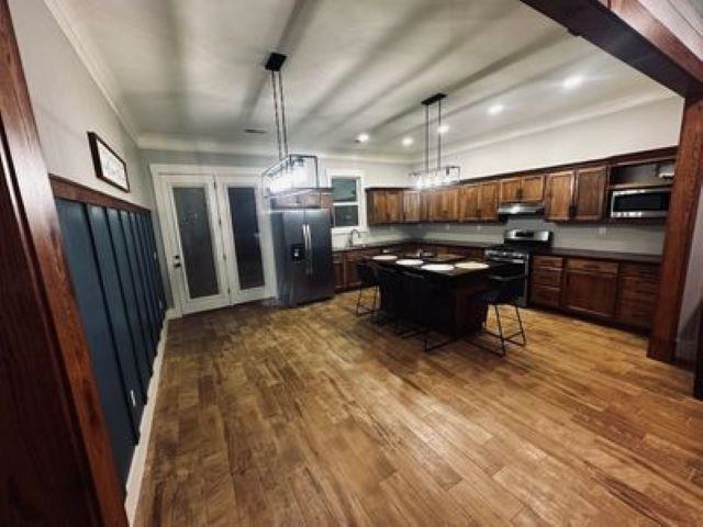 217 Liberty Road Jackson, TN 38305 - Photo 13 of 25 a kitchen with stainless steel appliances kitchen island granite countertop a refrigerator and a stove