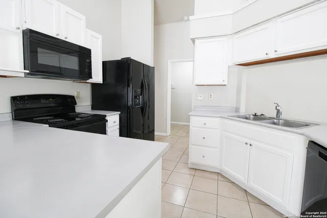 a kitchen with a refrigerator stove and microwave