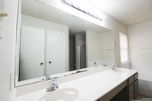 a bathroom with a sink double vanity and a mirror