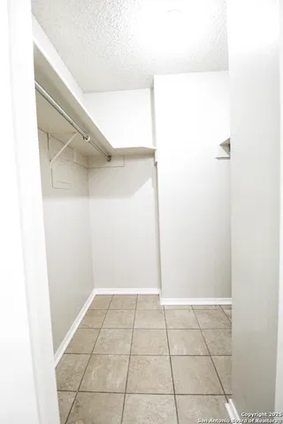 a view of a backyard with brick wall and a large window