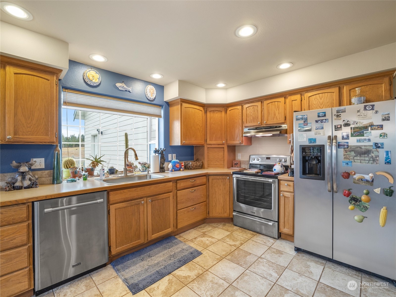 18615 Roseburg Street Southwest Rochester, WA 98579 - Photo 16 of 40 a kitchen with a sink stainless steel appliances and cabinets