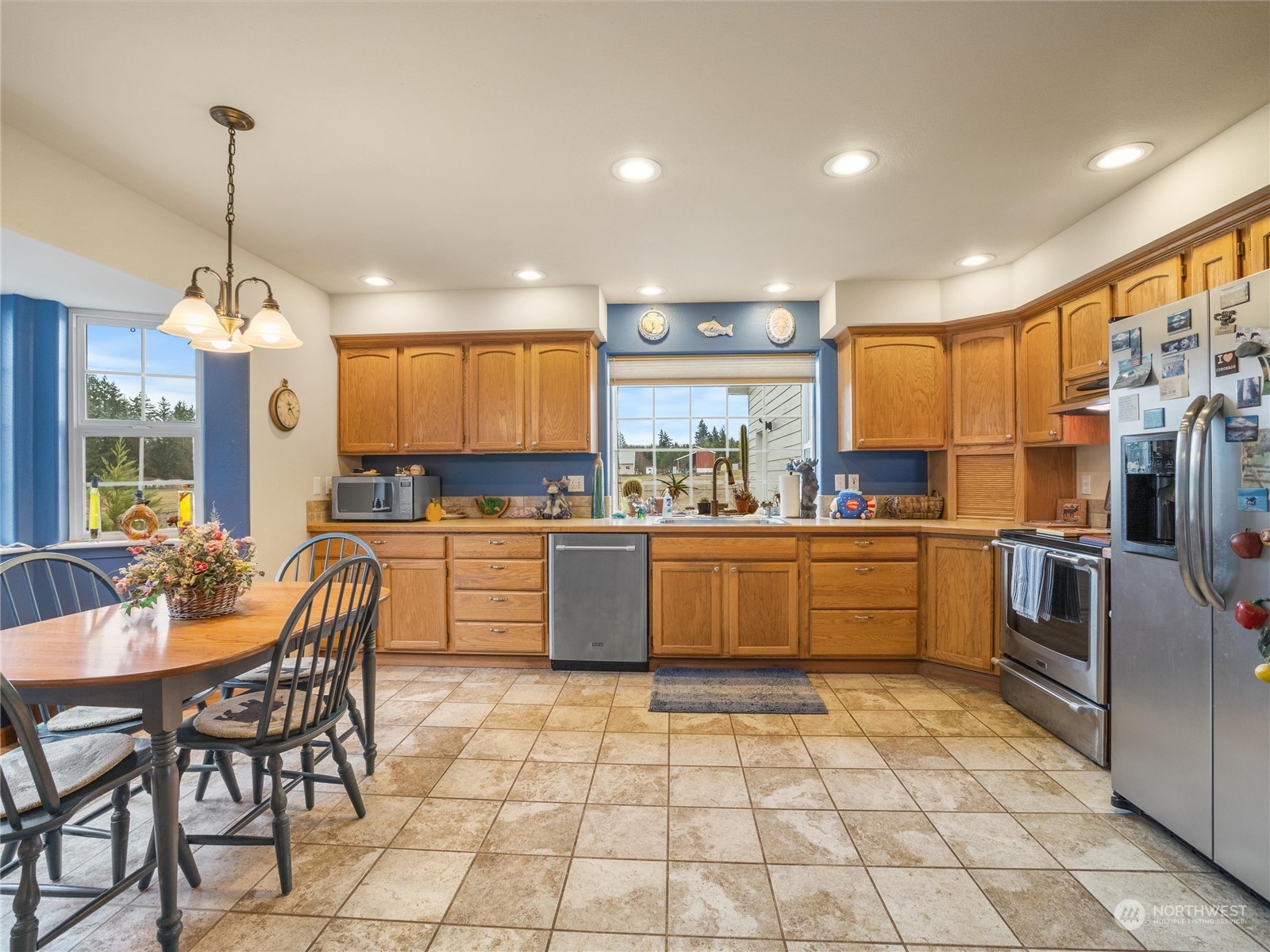 18615 Roseburg Street Southwest Rochester, WA 98579 - Photo 17 of 40 a kitchen with stainless steel appliances granite countertop a refrigerator a sink a stove and island