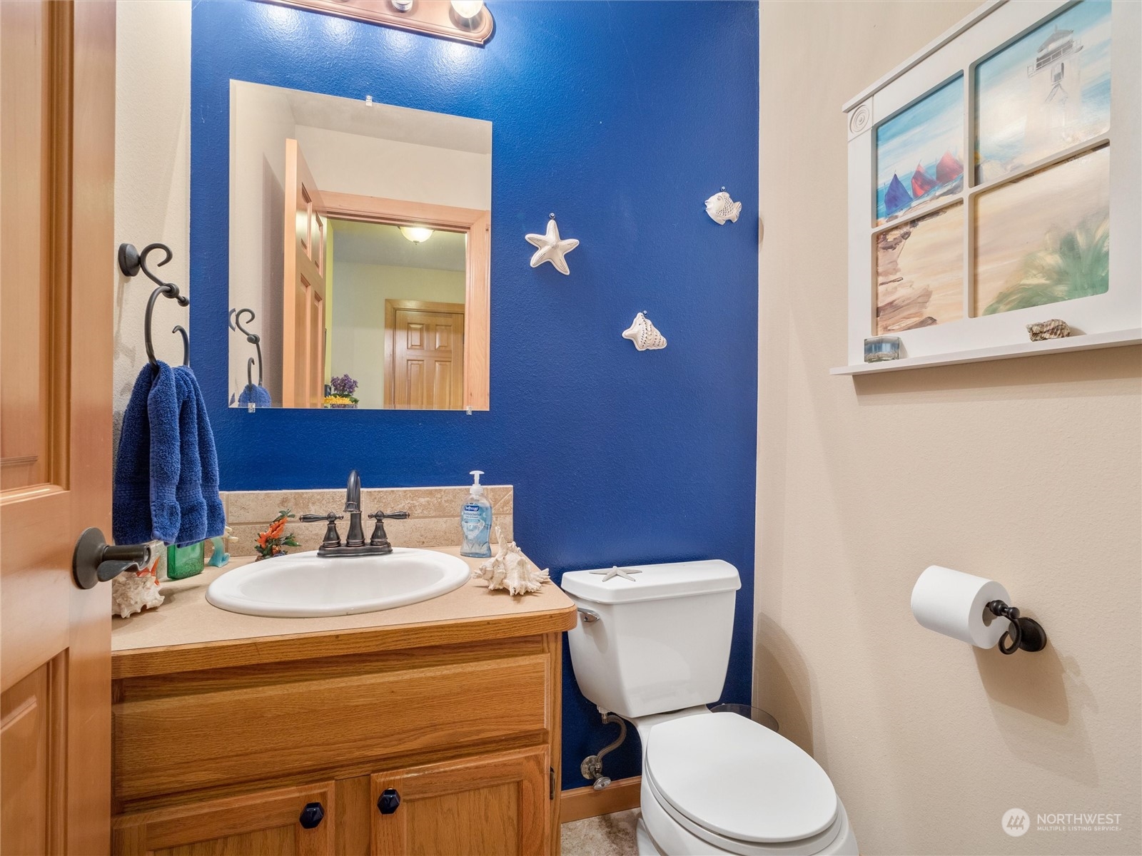 18615 Roseburg Street Southwest Rochester, WA 98579 - Photo 19 of 40 a bathroom with a toilet sink and mirror