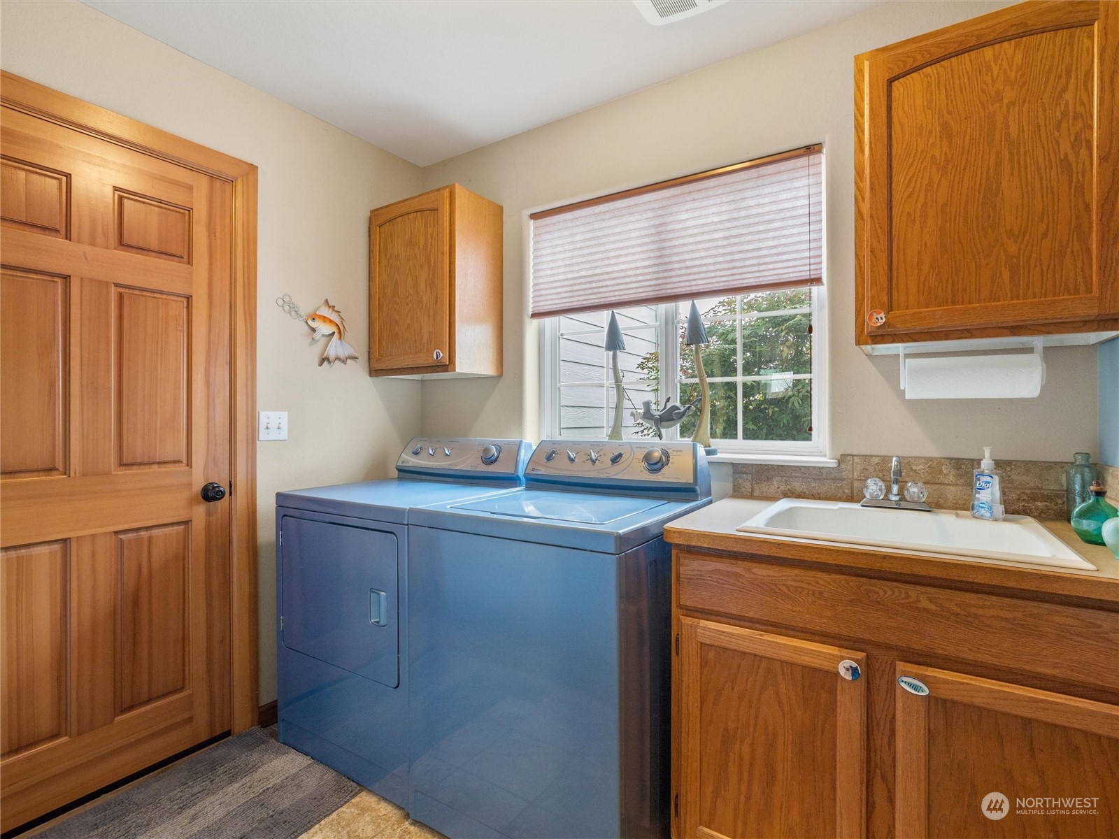 18615 Roseburg Street Southwest Rochester, WA 98579 - Photo 20 of 40 a kitchen with a sink cabinets appliances and a window