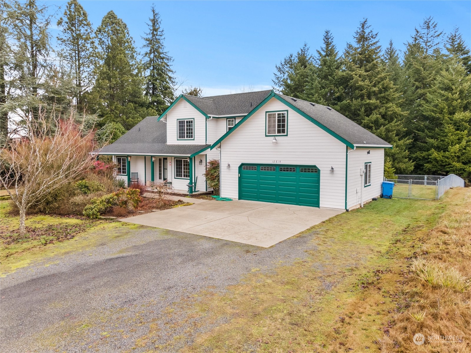 18615 Roseburg Street Southwest Rochester, WA 98579 - Photo 2 of 40 a front view of a house with a yard and garage