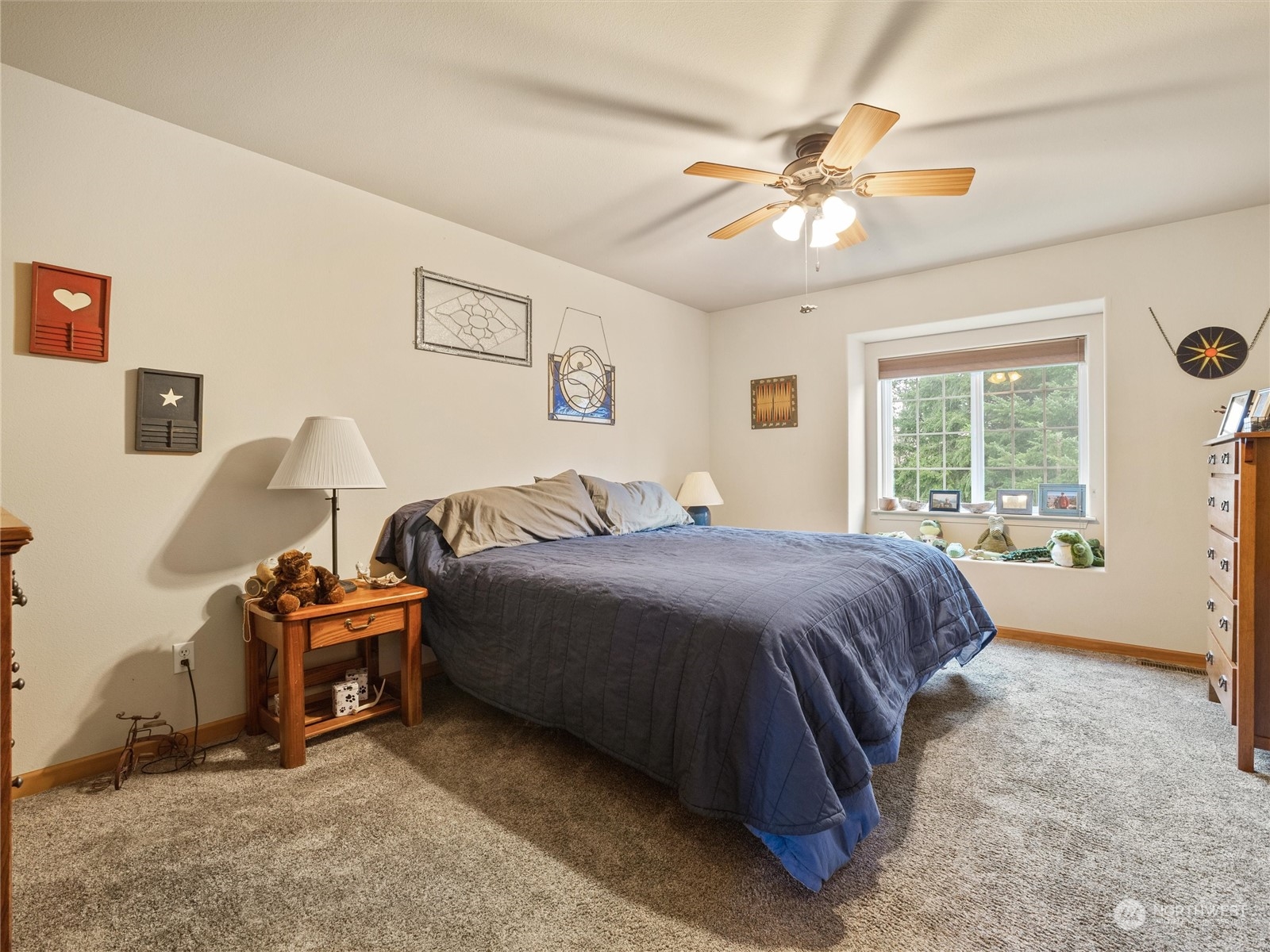 18615 Roseburg Street Southwest Rochester, WA 98579 - Photo 21 of 40 a bedroom with a bed and a chandelier