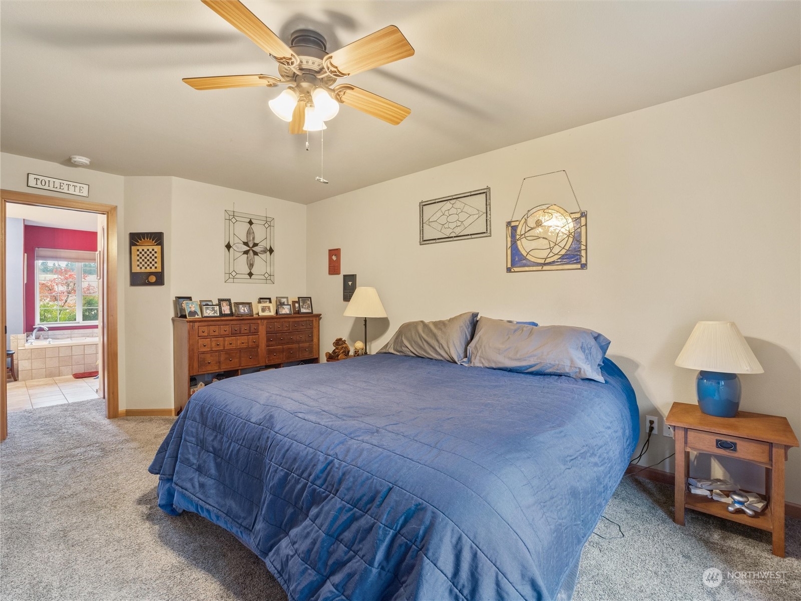 18615 Roseburg Street Southwest Rochester, WA 98579 - Photo 22 of 40 a bedroom with a bed and a chandelier