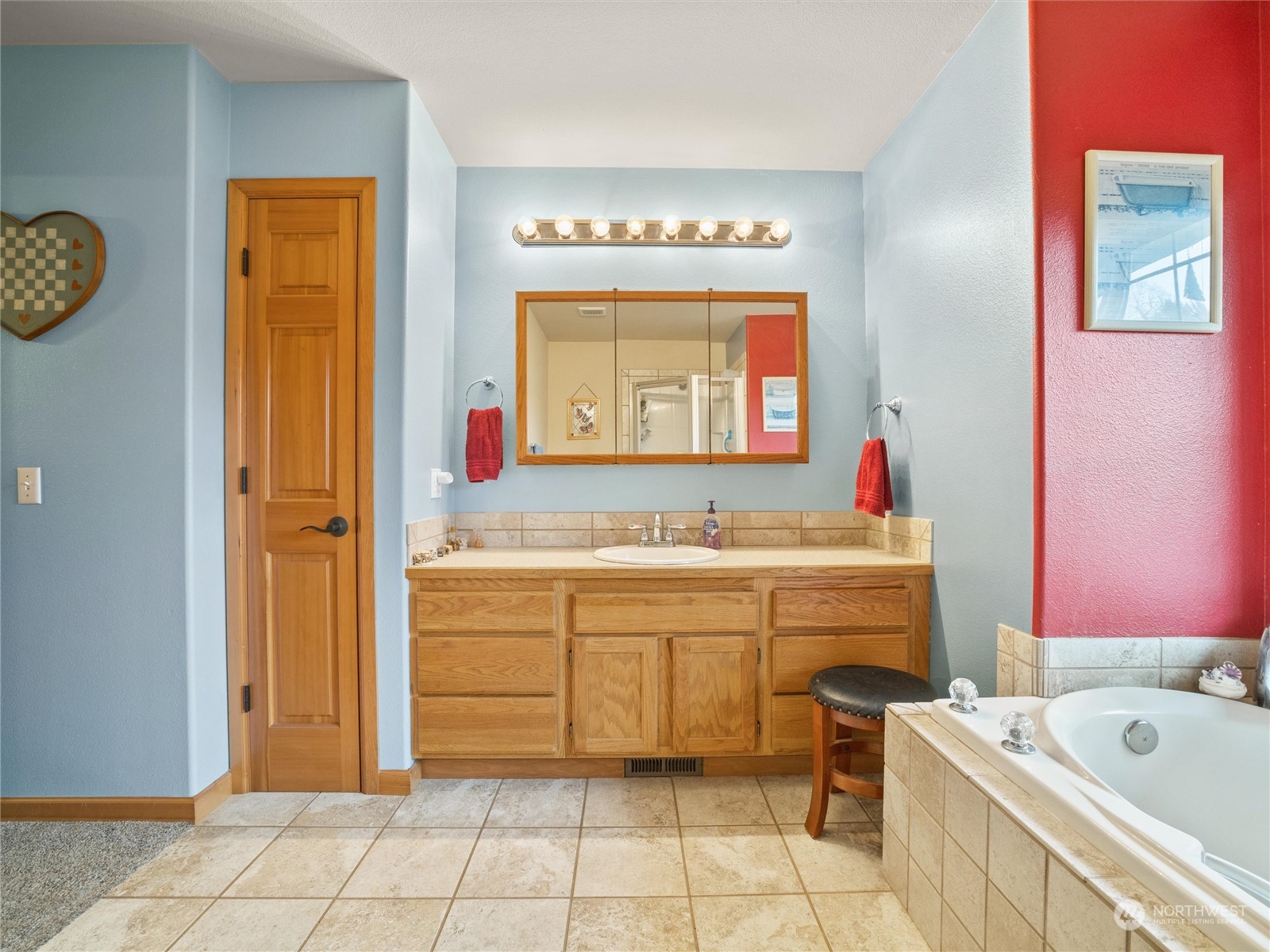 18615 Roseburg Street Southwest Rochester, WA 98579 - Photo 24 of 40 a bathroom with a bathtub sink and mirror