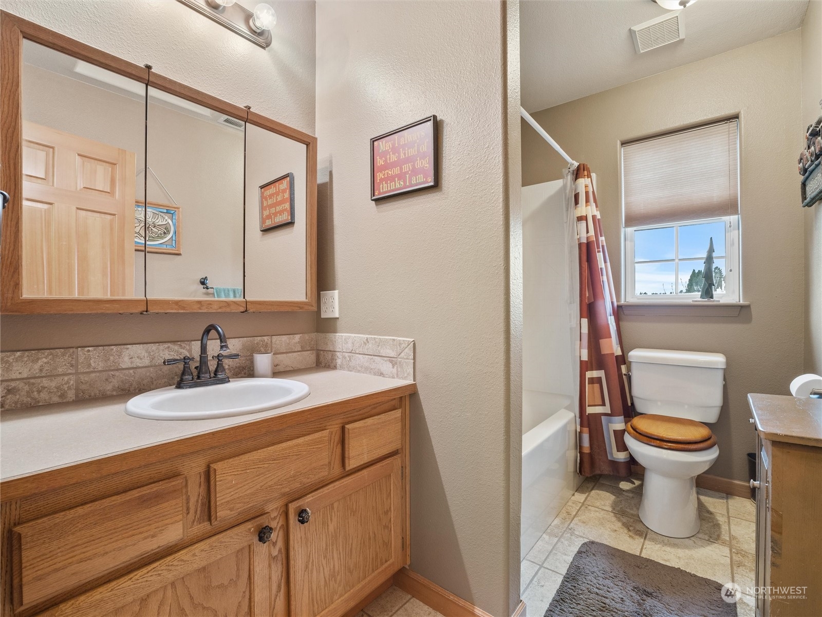 18615 Roseburg Street Southwest Rochester, WA 98579 - Photo 29 of 40 a bathroom with a sink toilet a mirror and vanity