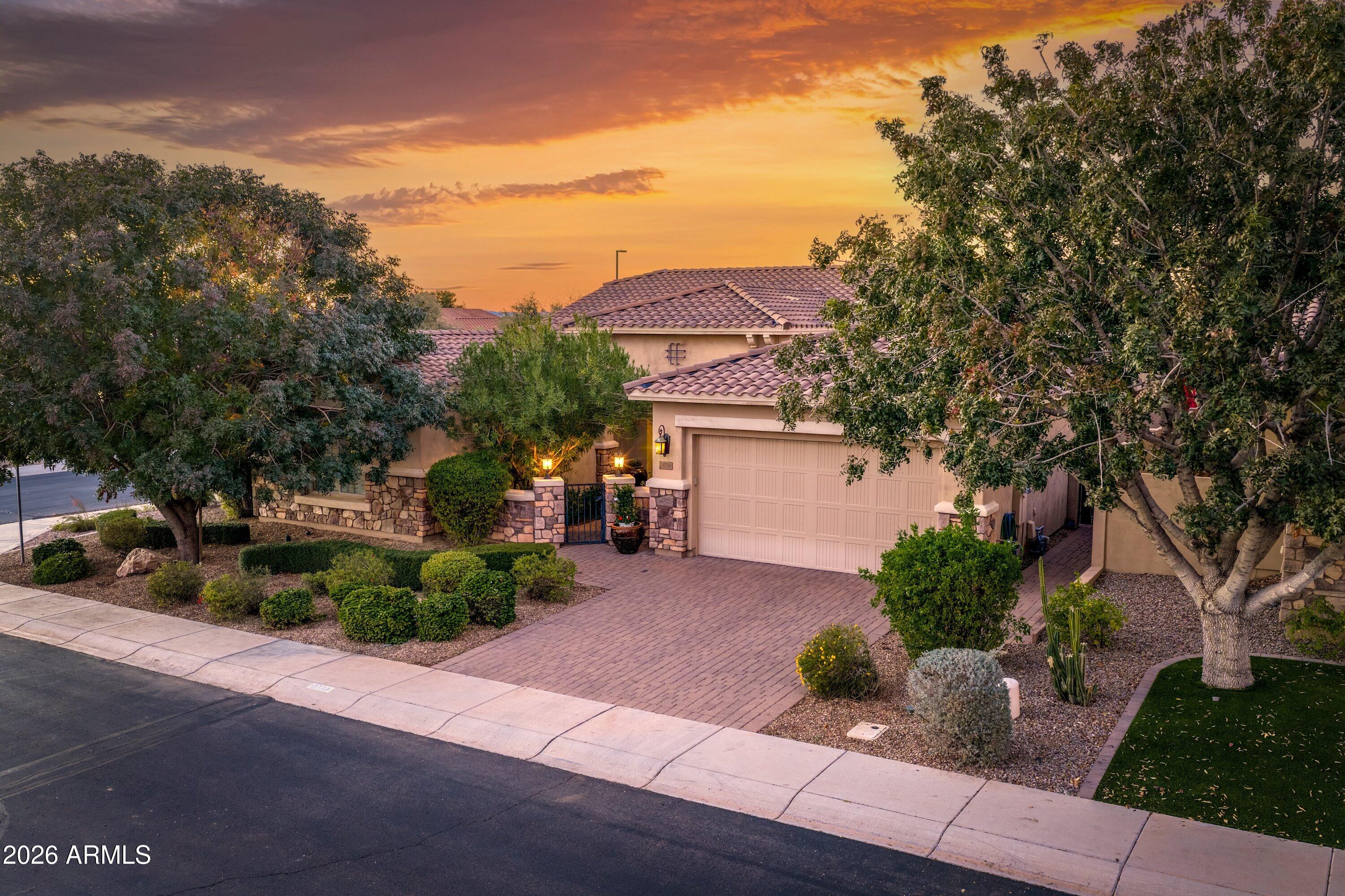a front view of a house with a yard and a garage
