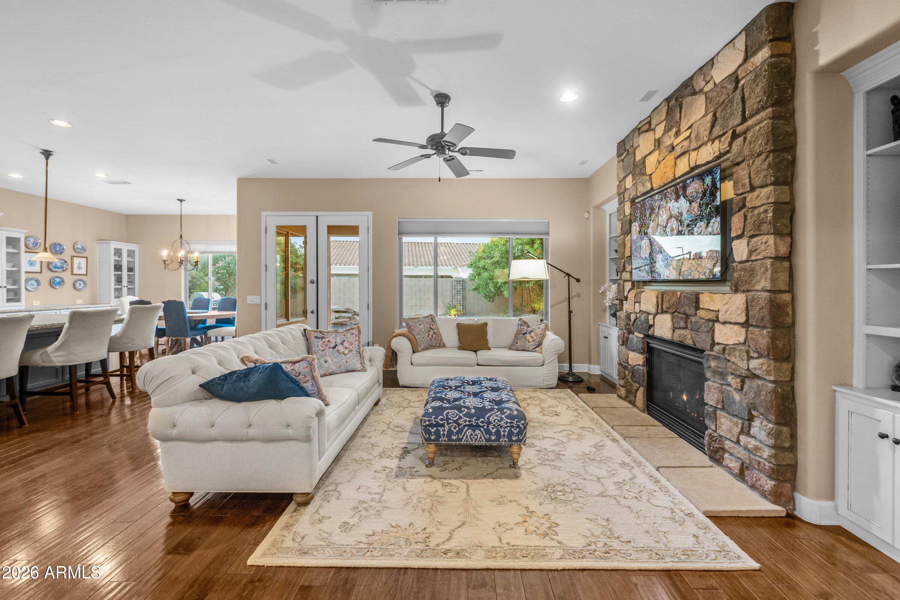 3738 East Riopelle Avenue Gilbert, AZ 85298 - Photo 13 of 97 a living room with furniture and a fireplace