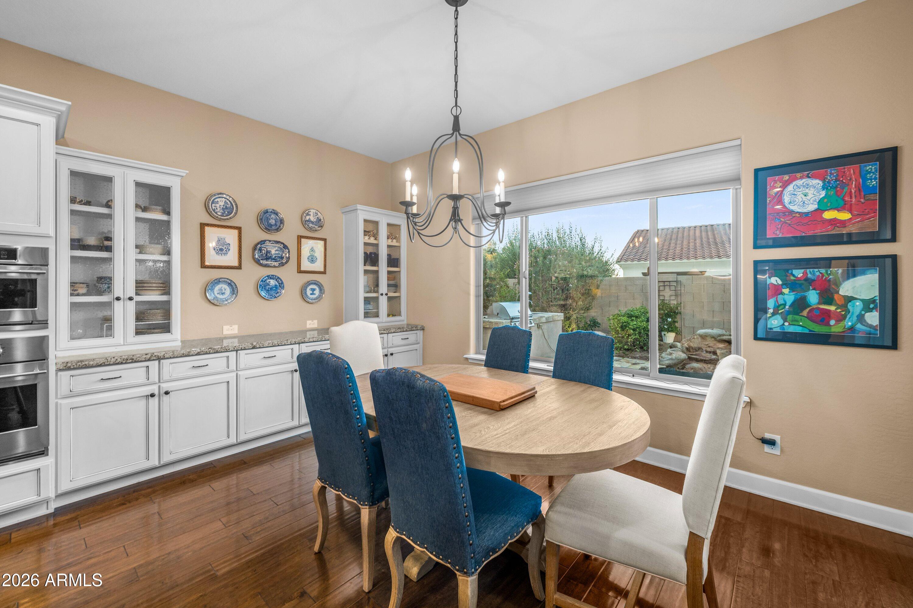 3738 East Riopelle Avenue Gilbert, AZ 85298 - Photo 24 of 97 a view of a dining room with furniture wooden floor and chandelier