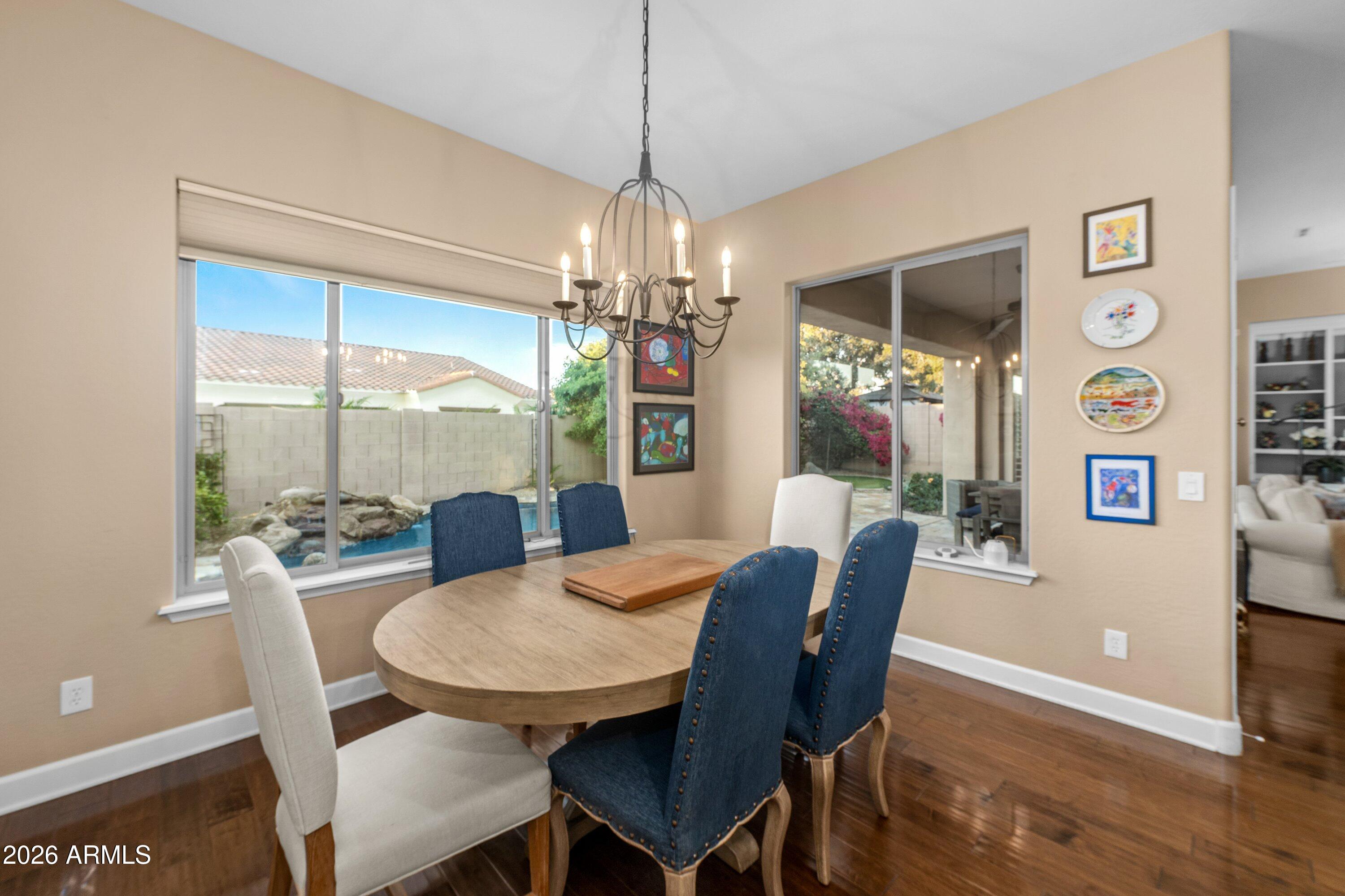 3738 East Riopelle Avenue Gilbert, AZ 85298 - Photo 25 of 97 a view of a dining room with furniture wooden floor and chandelier