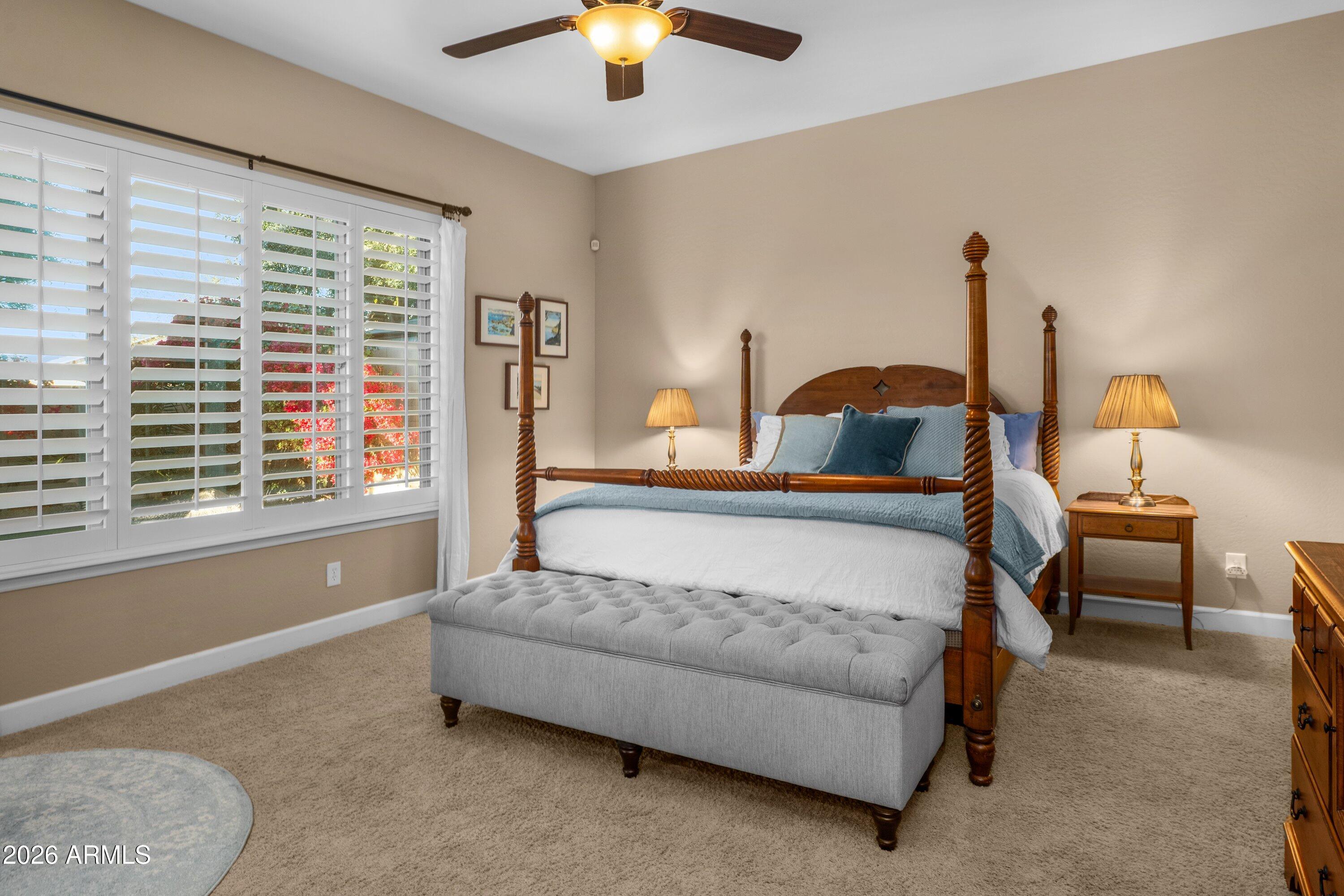 3738 East Riopelle Avenue Gilbert, AZ 85298 - Photo 27 of 97 a bedroom with a bed and a chandelier