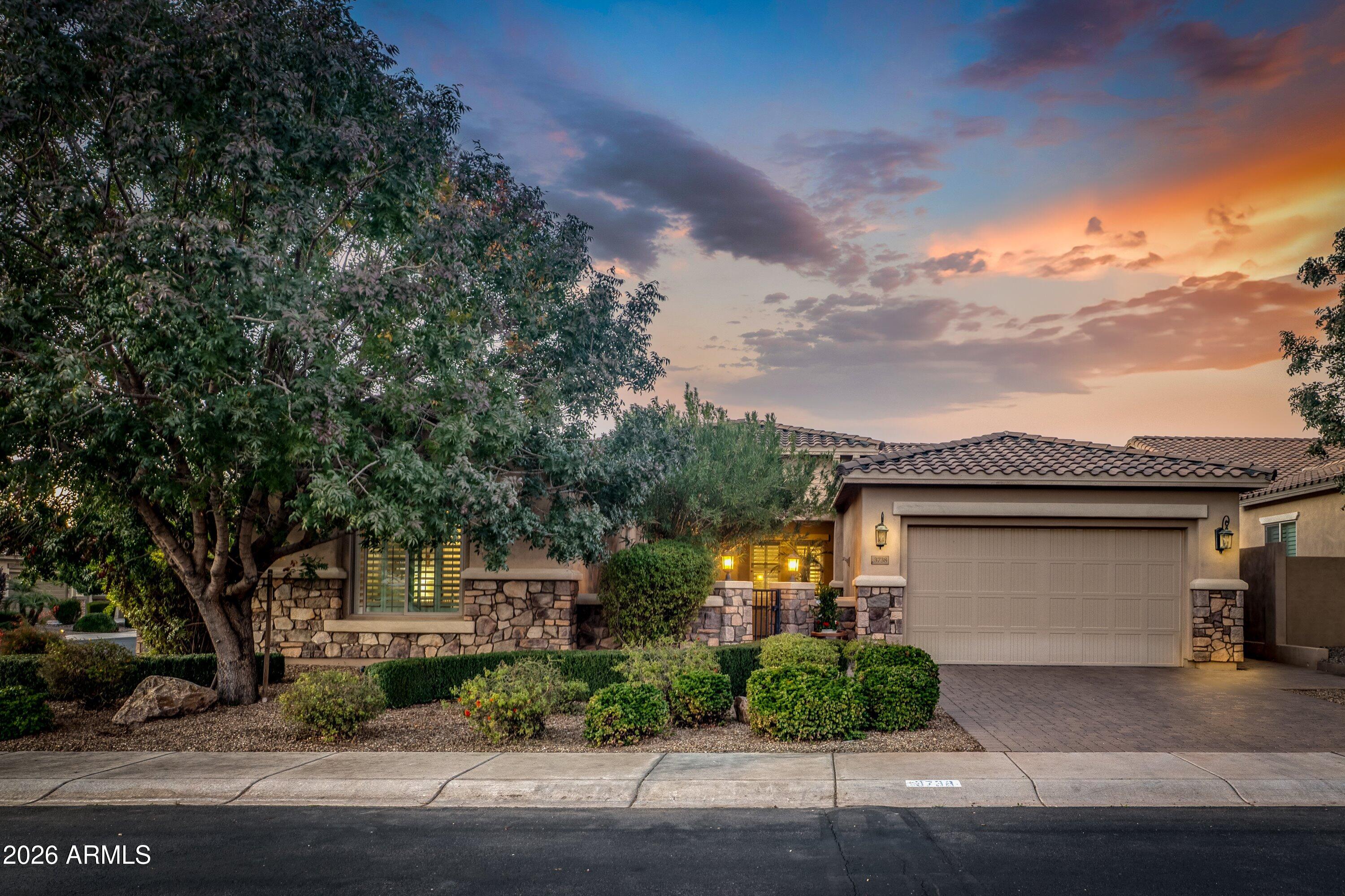 3738 East Riopelle Avenue Gilbert, AZ 85298 - Photo 2 of 97 a front view of a house with a garden and plants