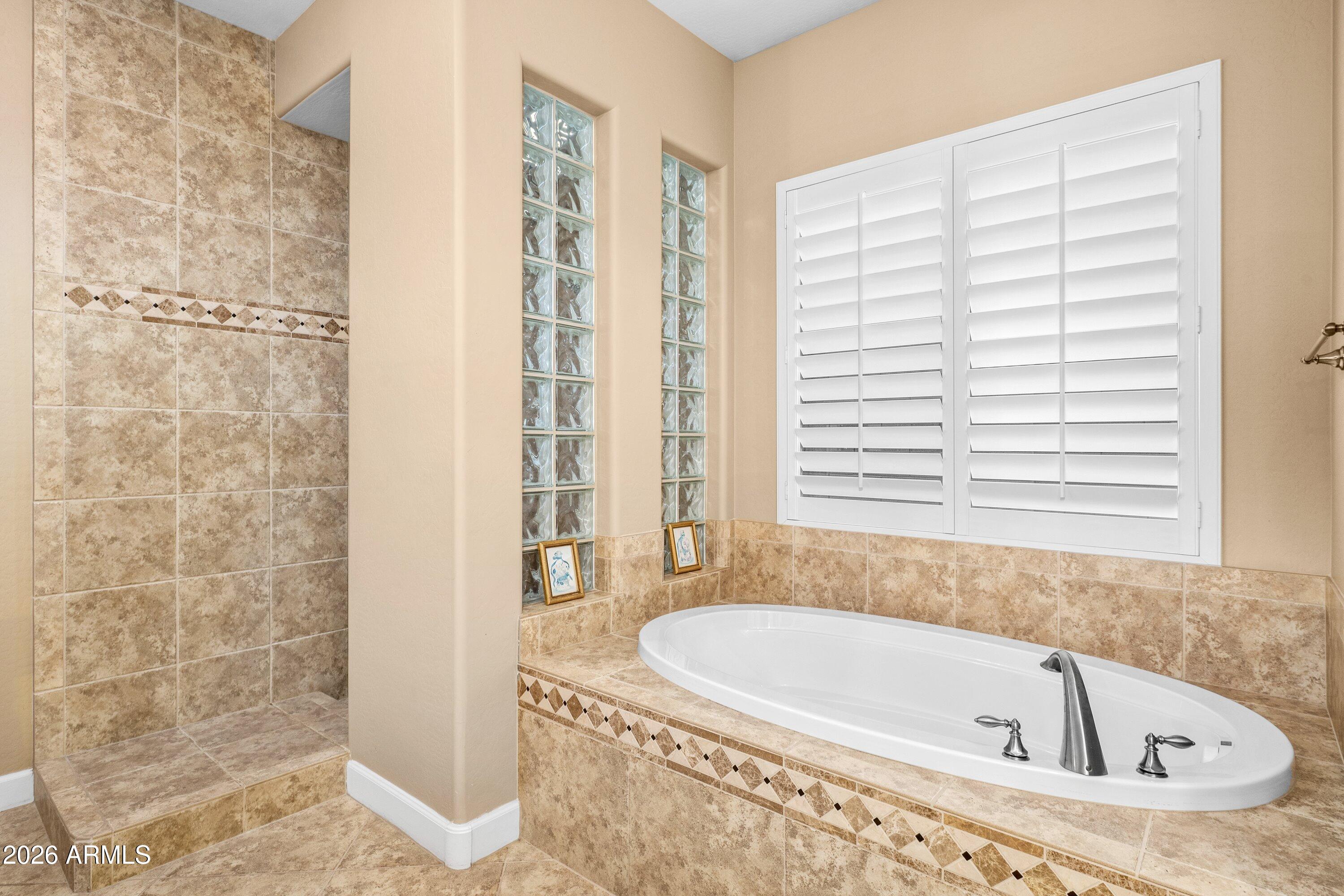 3738 East Riopelle Avenue Gilbert, AZ 85298 - Photo 34 of 97 a bathroom with a bathtub and shower