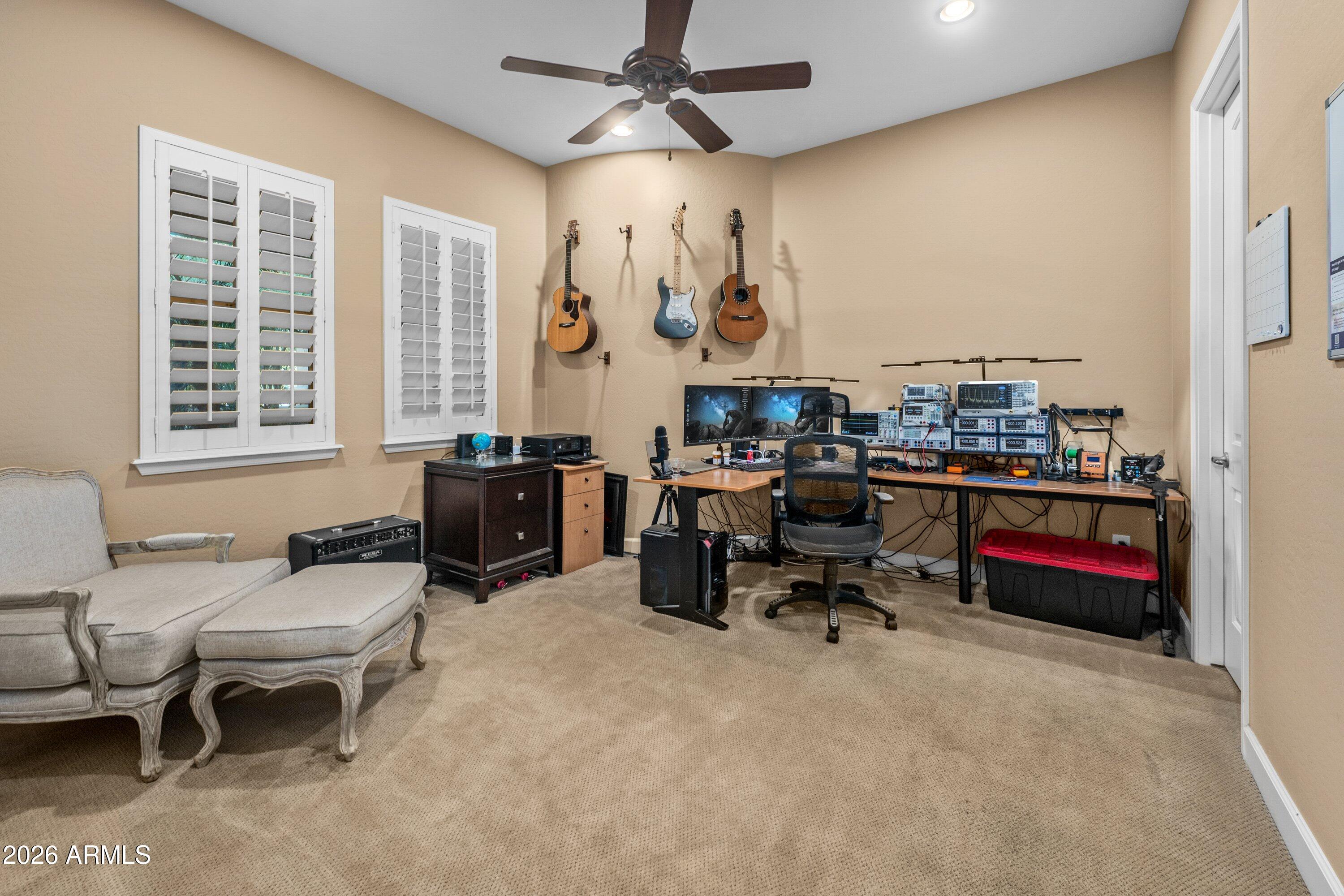 3738 East Riopelle Avenue Gilbert, AZ 85298 - Photo 42 of 97 a living room with furniture gym equipment and a window