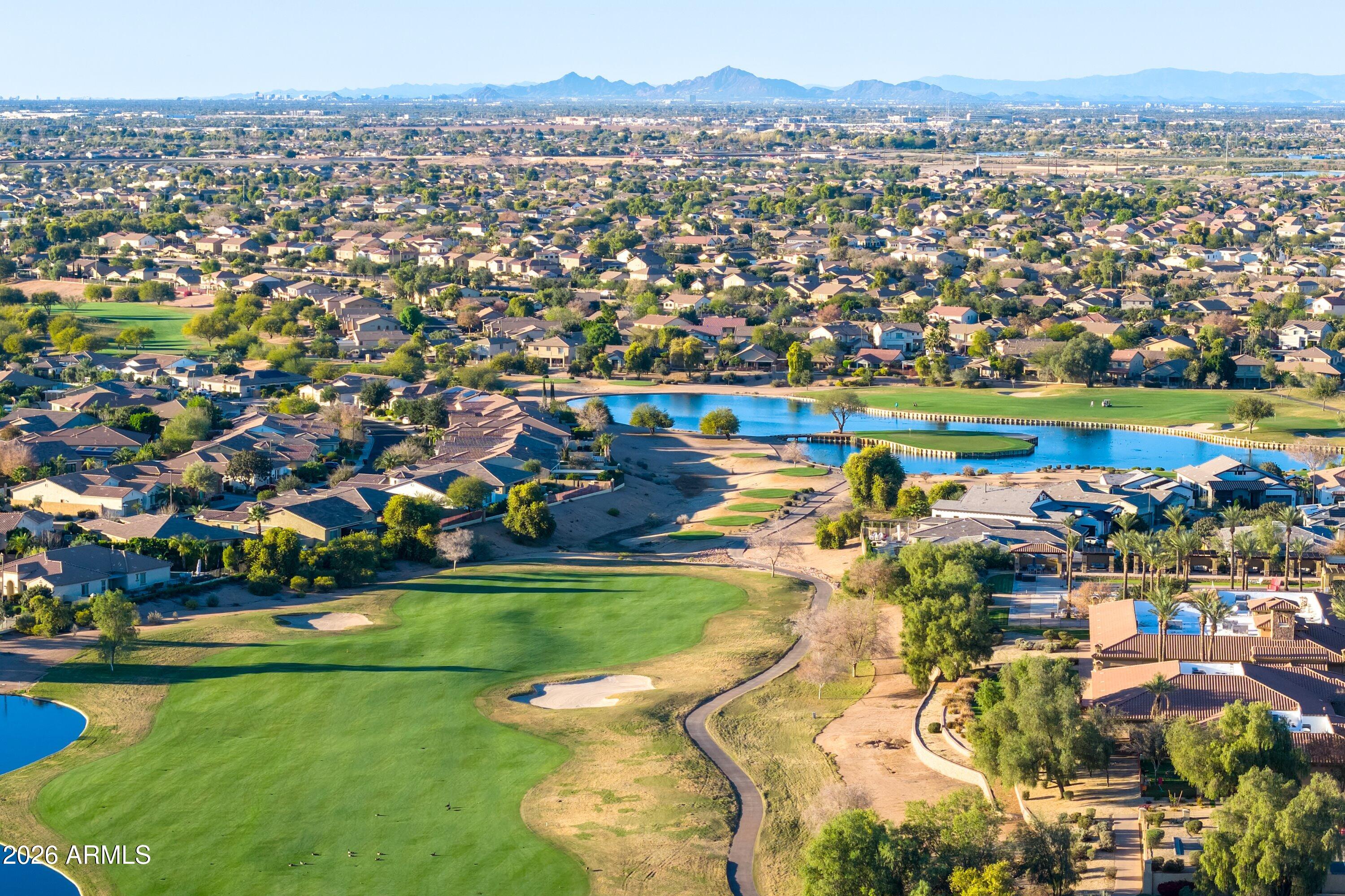3738 East Riopelle Avenue Gilbert, AZ 85298 - Photo 74 of 97 an aerial view of a city with lots of residential buildings and mountain view in back