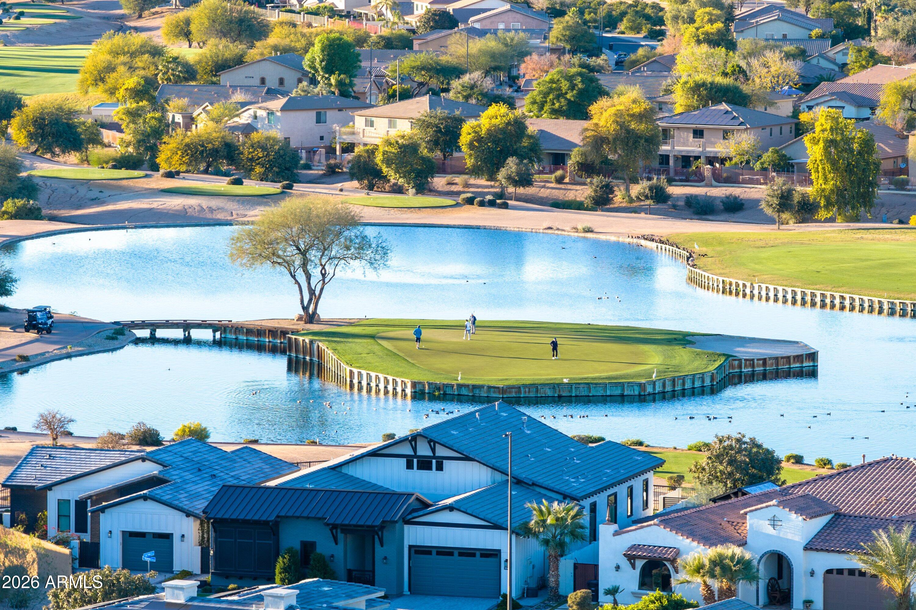 3738 East Riopelle Avenue Gilbert, AZ 85298 - Photo 77 of 97 a view of a swimming pool with lawn chairs under an umbrella