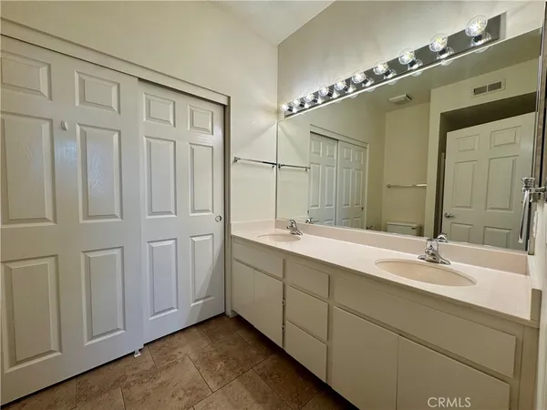 a bathroom with a double vanity sink and a mirror