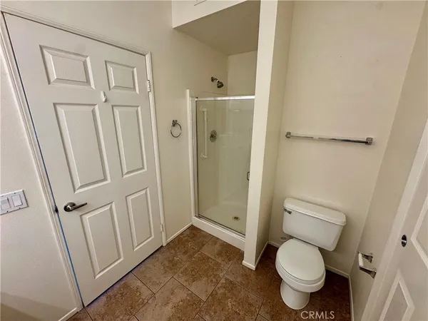 a bathroom with a toilet and a shower
