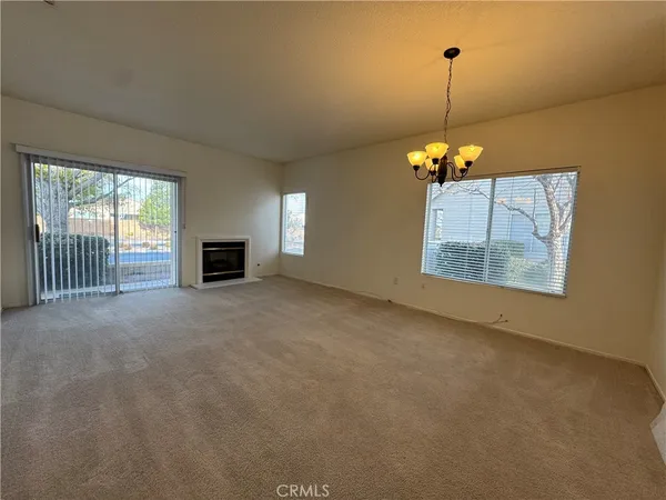 a view of empty room with a fireplace