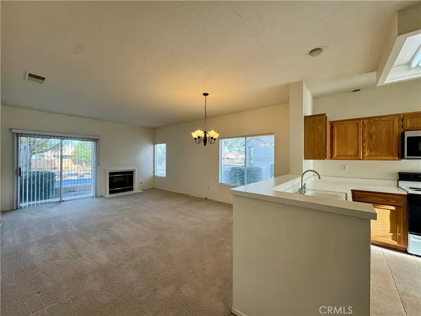 a view of a kitchen with a sink and a fireplace