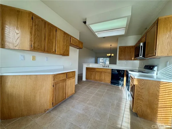 a kitchen with stainless steel appliances granite countertop a sink counter space cabinets and a large window