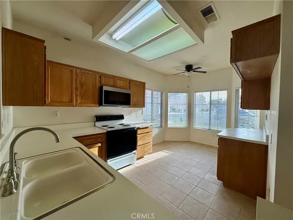 a kitchen with stainless steel appliances granite countertop a sink and a stove