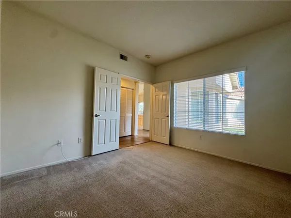 an empty room with a empty space and windows