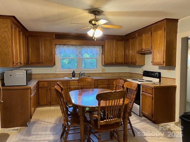 70 3rd Street, Unit 87 Marion, NC 28752 - Photo 5 of 22 a kitchen with stainless steel appliances a table chairs and a refrigerator