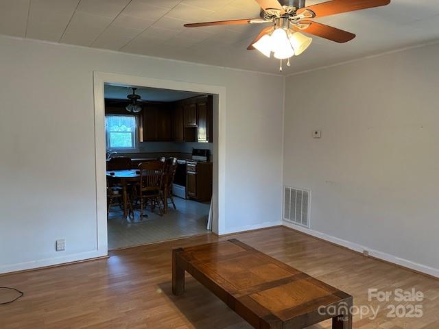 70 3rd Street, Unit 87 Marion, NC 28752 - Photo 9 of 22 an empty room with wooden floor fan and windows