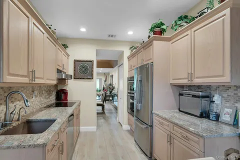 a kitchen with stainless steel appliances a stove microwave and a refrigerator