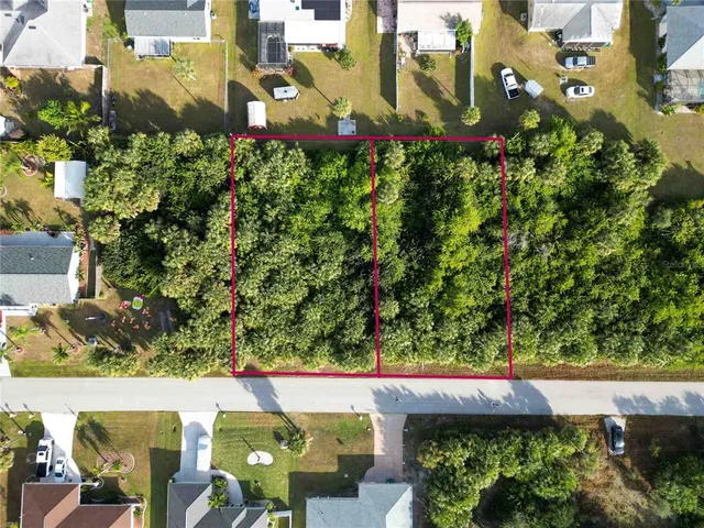 an aerial view of a residential houses with outdoor space