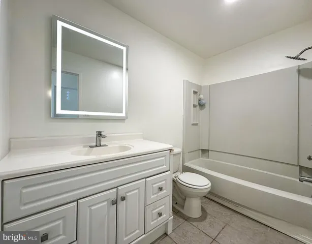 a bathroom with a sink a toilet and a bathtub