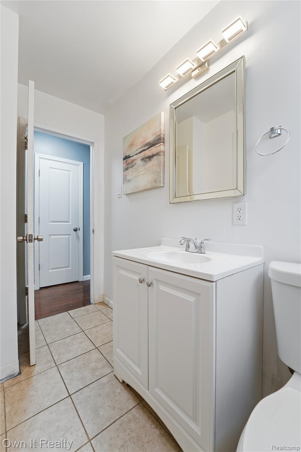 26772 Colgate Street Inkster, MI 48141 - Photo 14 of 25 Bathroom featuring a vanity with a white countertop and integrated sink, a rectangular framed mirror, and a four-light fixture