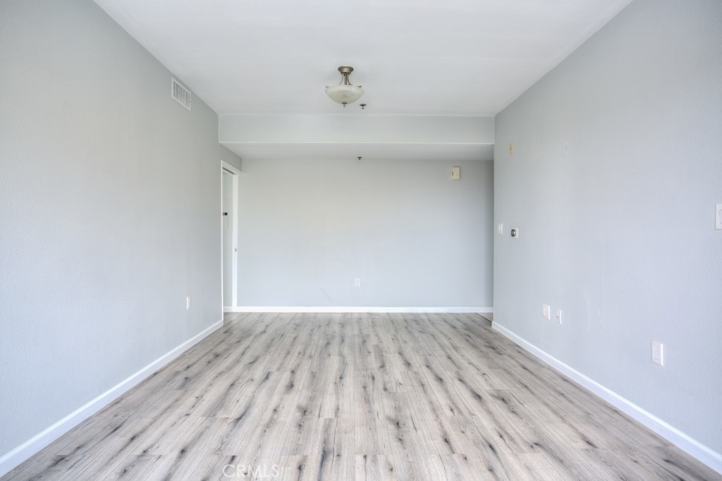 580 West Main Street, Unit 302 Alhambra, CA 91801 - Photo 11 of 41 a view of an empty room with wooden floor
