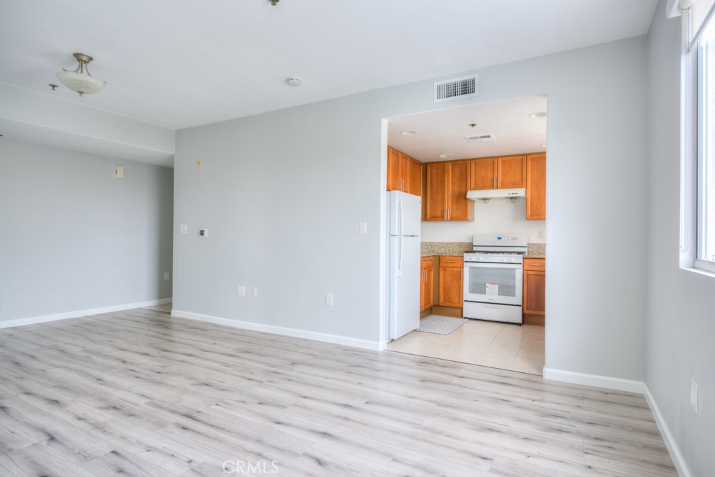 580 West Main Street, Unit 302 Alhambra, CA 91801 - Photo 12 of 41 a view of kitchen with wooden floor electronic appliances and window