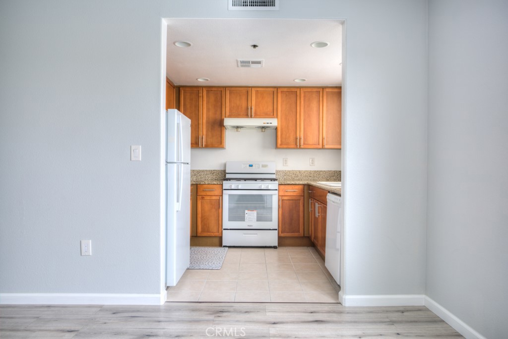 580 West Main Street, Unit 302 Alhambra, CA 91801 - Photo 14 of 41 a kitchen with a white stove top oven and cabinets