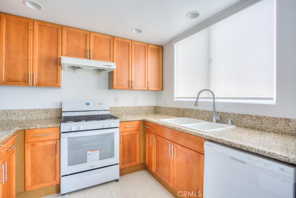 580 West Main Street, Unit 302 Alhambra, CA 91801 - Photo 16 of 41 a kitchen with stainless steel appliances granite countertop a sink stove and cabinets