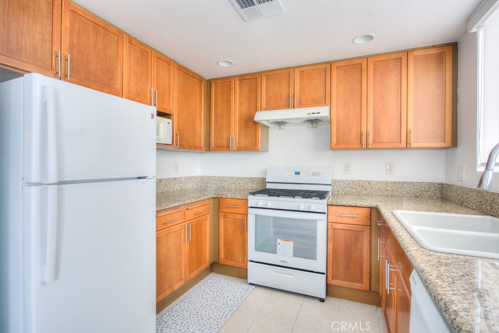 580 West Main Street, Unit 302 Alhambra, CA 91801 - Photo 17 of 41 a kitchen with stainless steel appliances granite countertop a refrigerator sink and cabinets