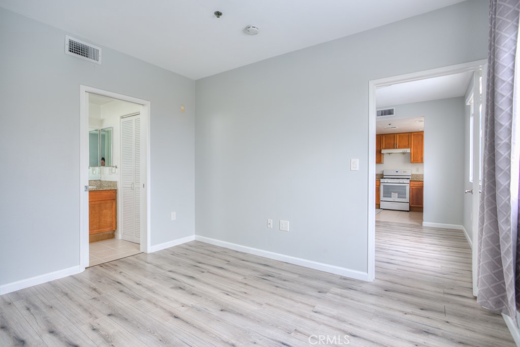 580 West Main Street, Unit 302 Alhambra, CA 91801 - Photo 19 of 41 an empty room with wooden floor and a bathroom
