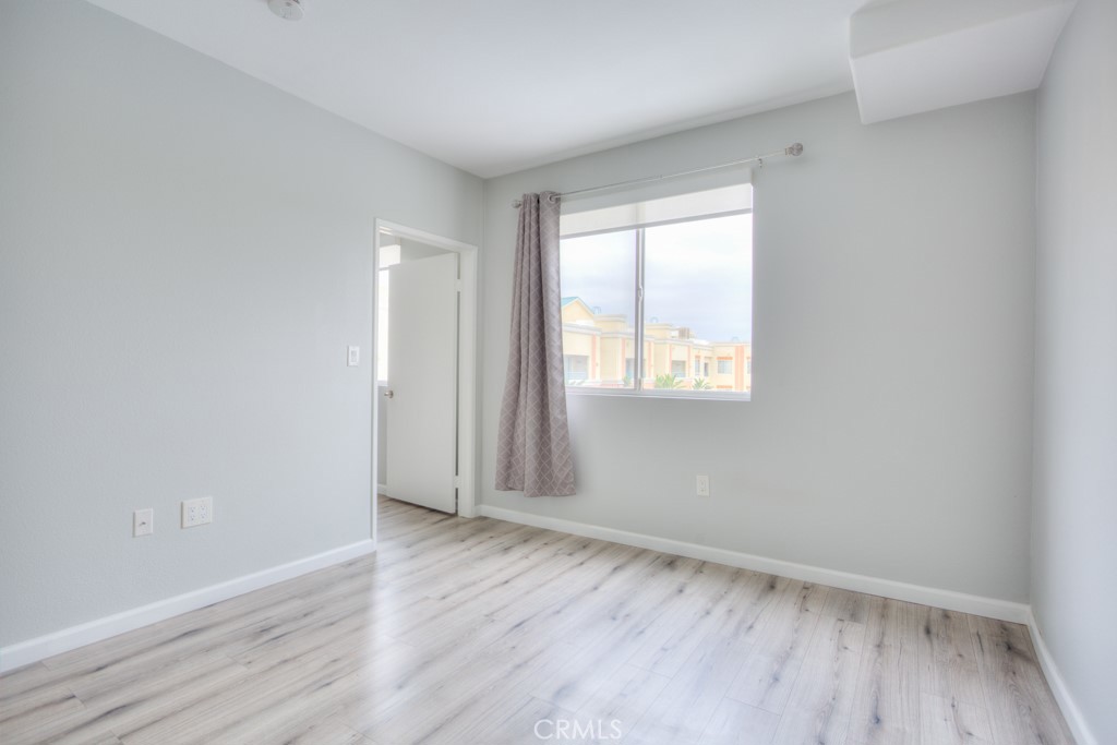 580 West Main Street, Unit 302 Alhambra, CA 91801 - Photo 20 of 41 an empty room with wooden floor and windows