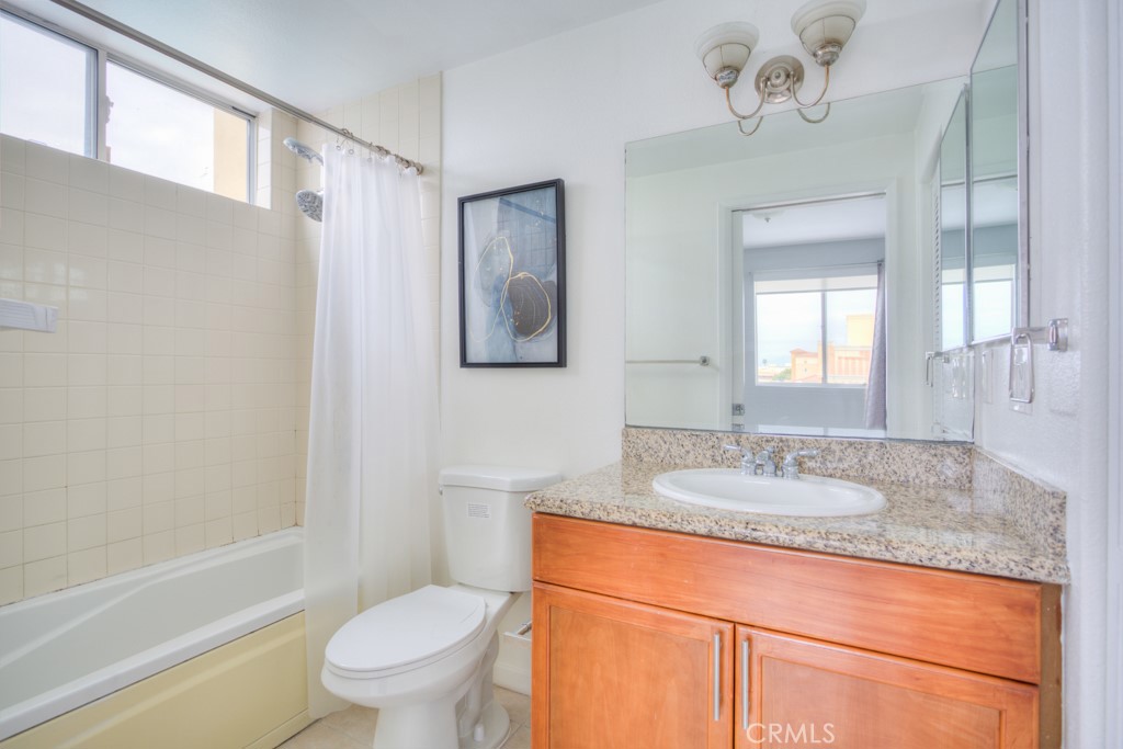 580 West Main Street, Unit 302 Alhambra, CA 91801 - Photo 23 of 41 a bathroom with a granite countertop sink toilet and shower