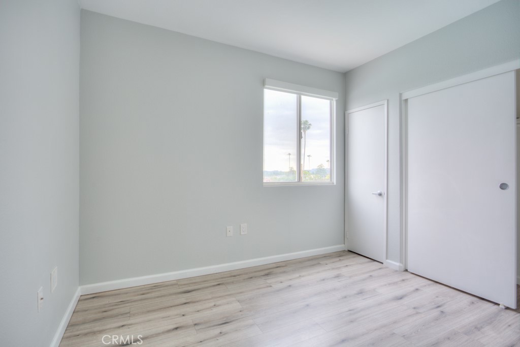580 West Main Street, Unit 302 Alhambra, CA 91801 - Photo 26 of 41 an empty room with wooden floor and windows