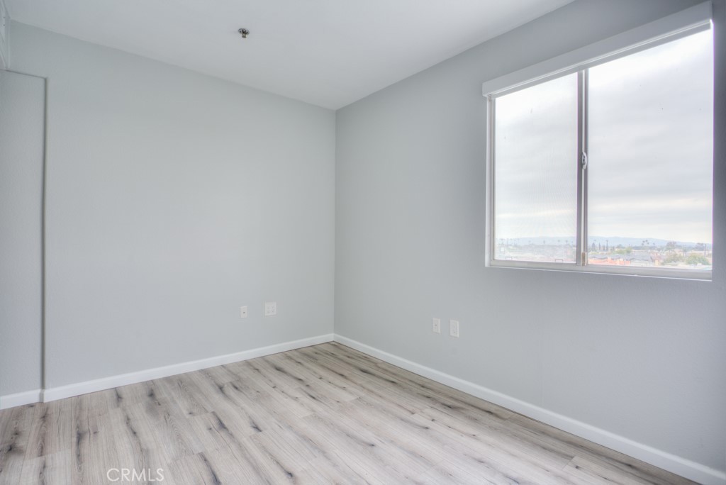 580 West Main Street, Unit 302 Alhambra, CA 91801 - Photo 28 of 41 an empty room with wooden floor and windows